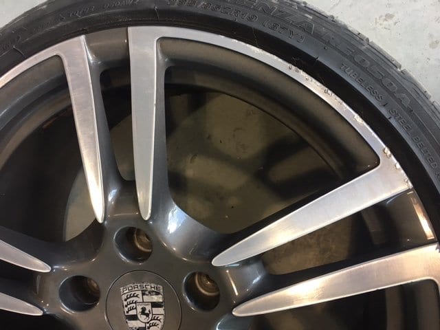 Curbed porsche alloy